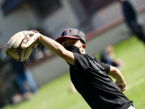 boy catching baseball