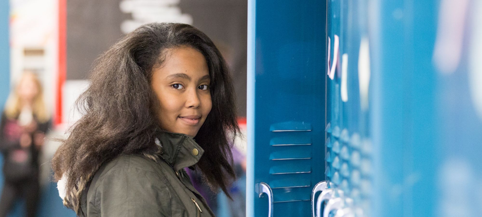 Gateway High School student in front of locker